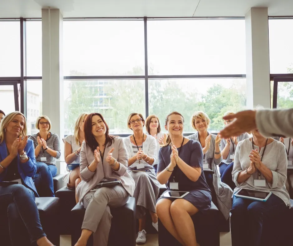 Women applauding during a community event
